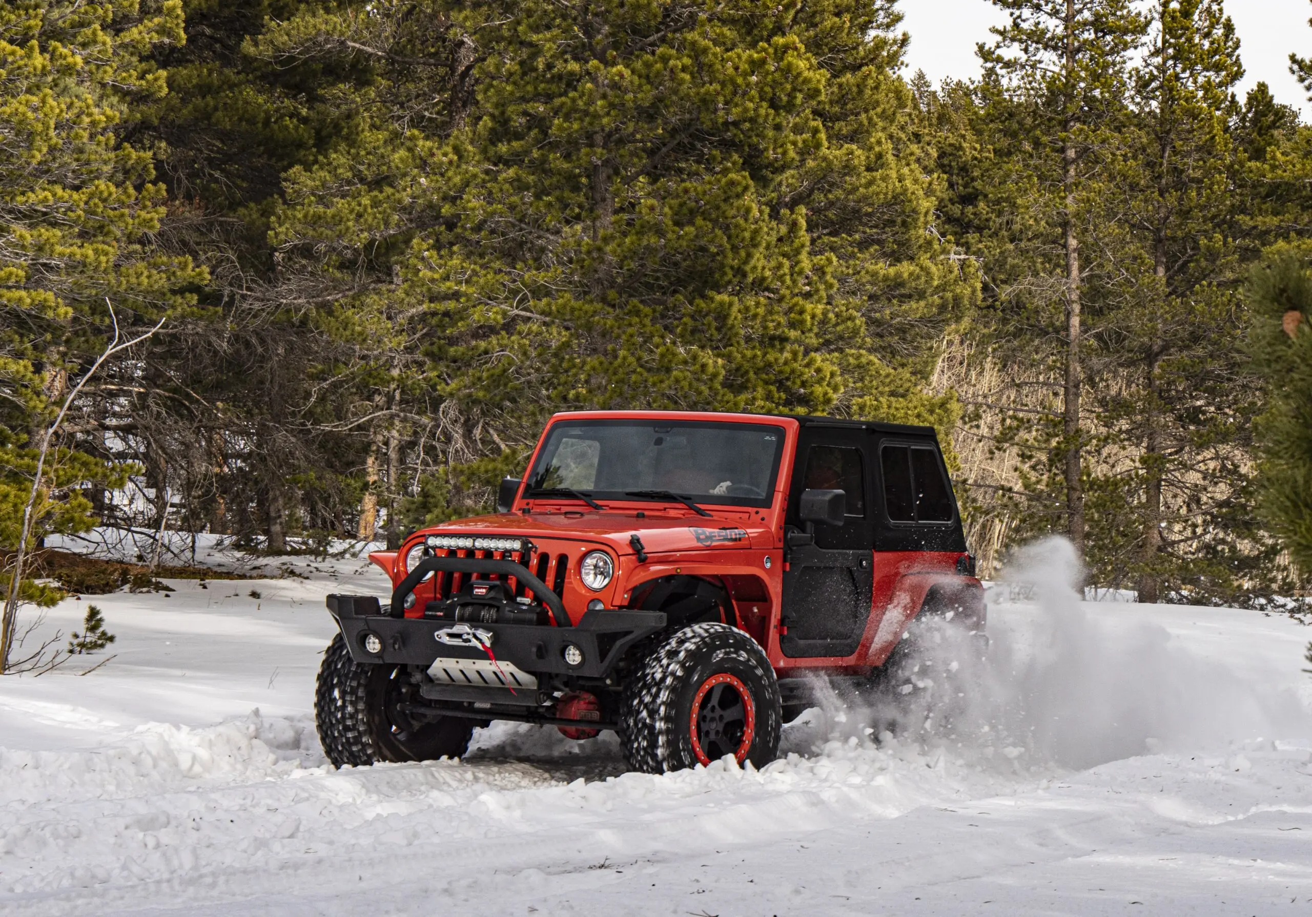 Bestop-equipped Jeep Wrangler driving through the snow